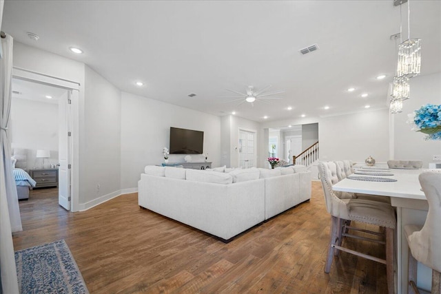 living room with ceiling fan and dark hardwood / wood-style flooring