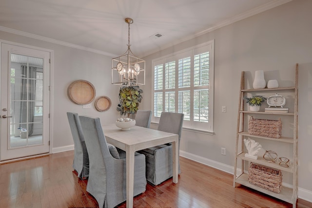 2036 Kings Gate Ln, Mount Pleasant, SC 29466 - dining area with wood-type flooring, a chandelier, and ornamental molding
