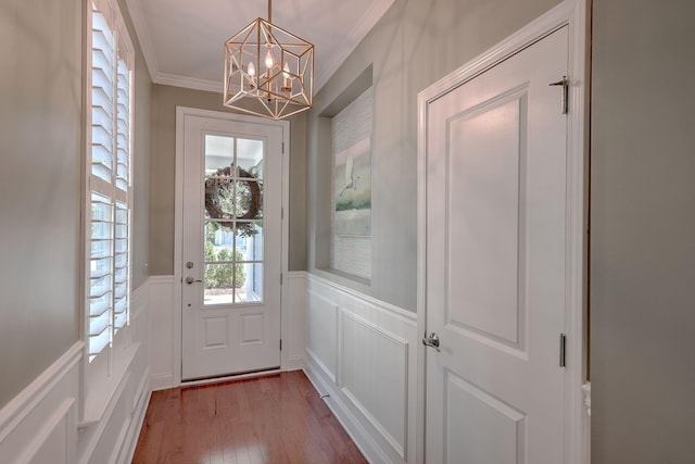 2036 Kings Gate Ln, Mount Pleasant, SC 29466 - entryway featuring ornamental molding, a chandelier, a decorative wall, wood finished floors, and wainscoting