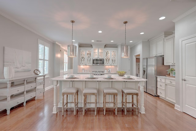 2036 Kings Gate Ln, Mount Pleasant, SC 29466 - kitchen featuring stainless steel appliances, ornamental molding, white cabinets, a kitchen island, and recessed lighting