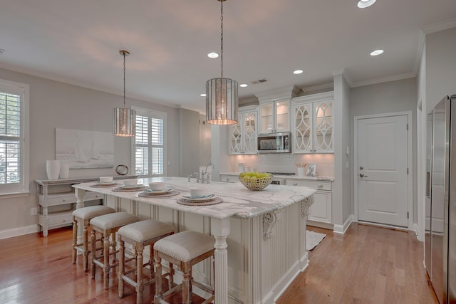 2036 Kings Gate Ln, Mount Pleasant, SC 29466 - kitchen featuring stainless steel appliances, healthy amount of natural light, light wood-style floors, backsplash, and crown molding