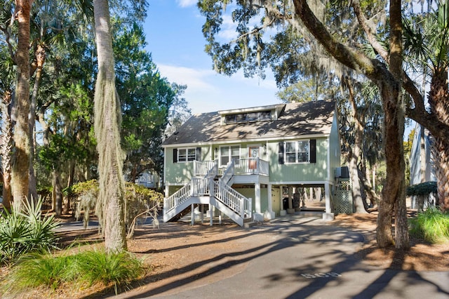 coastal inspired home with a carport and covered porch