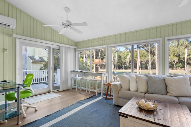 sunroom / solarium featuring ceiling fan, a wall mounted AC, and vaulted ceiling