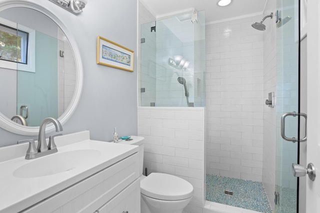 bathroom featuring vanity, toilet, and walk in shower