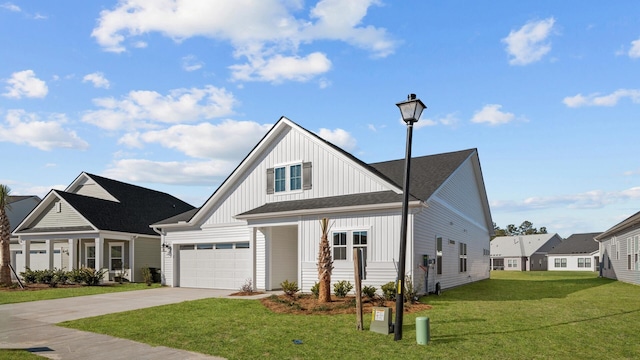 modern farmhouse style home featuring a garage, a front yard, concrete driveway, and board and batten siding