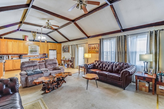 carpeted living room featuring lofted ceiling with beams, a healthy amount of sunlight, and ceiling fan