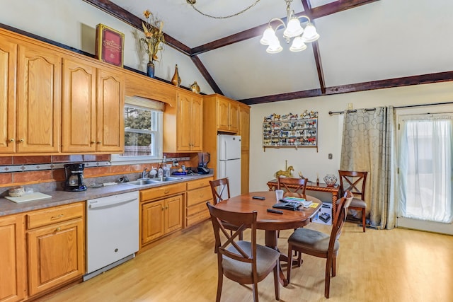 kitchen with an inviting chandelier, white appliances, sink, light wood-type flooring, and vaulted ceiling with beams