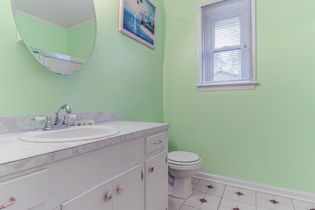 bathroom featuring tile patterned flooring, vanity, toilet, and ornamental molding