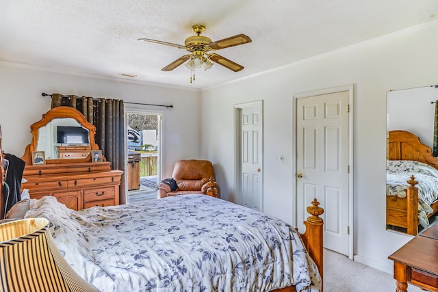 carpeted bedroom with ceiling fan, a textured ceiling, and ornamental molding