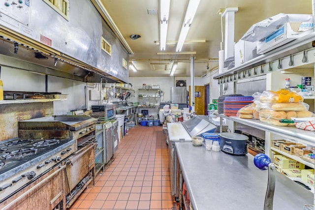 kitchen with black gas stovetop and light tile patterned flooring