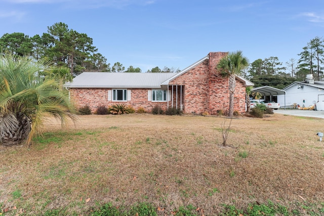 ranch-style house with a carport and a front lawn