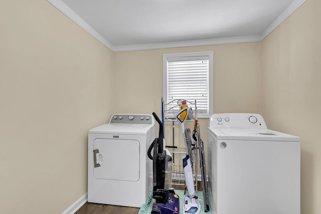 washroom featuring wood-type flooring, washer and dryer, and ornamental molding