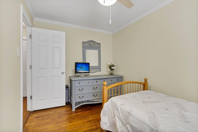 bedroom with wood-type flooring, ceiling fan, and crown molding