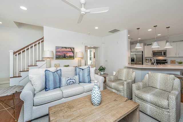 living area with stairway, recessed lighting, visible vents, and ceiling fan