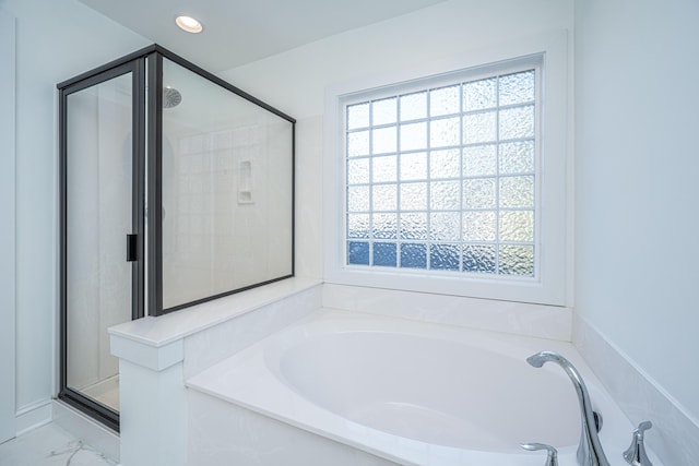 bathroom featuring a shower stall, a garden tub, recessed lighting, and marble finish floor