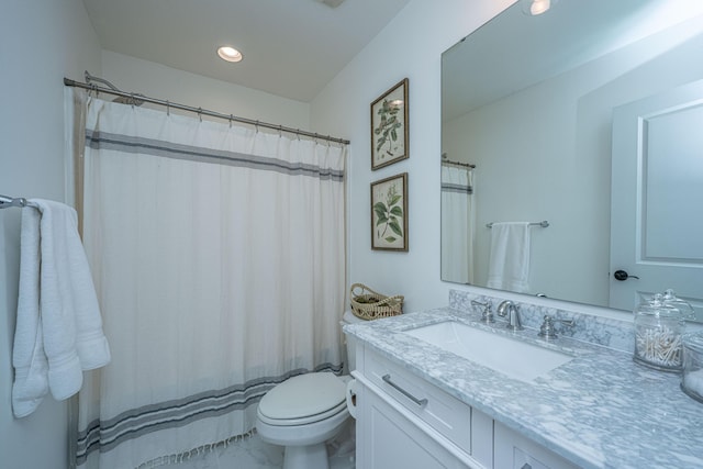 bathroom with recessed lighting, toilet, and vanity