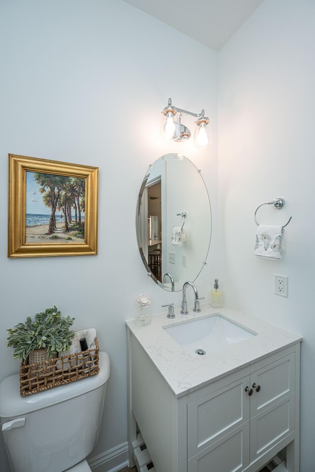 bathroom featuring toilet and vanity