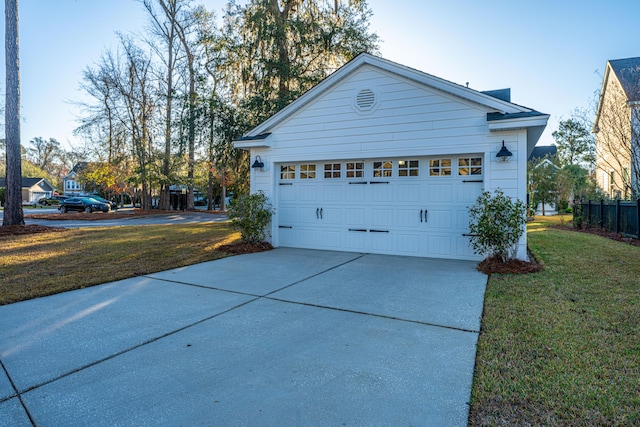 view of side of property featuring a lawn and a garage