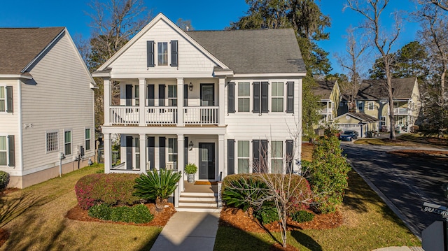 view of front of house with a balcony and roof with shingles