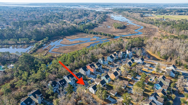 aerial view featuring a forest view, a water view, and a residential view