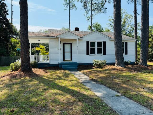 ranch-style home with a front lawn