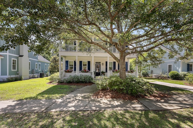 view of front of house with covered porch, a front lawn, central air condition unit, and a balcony