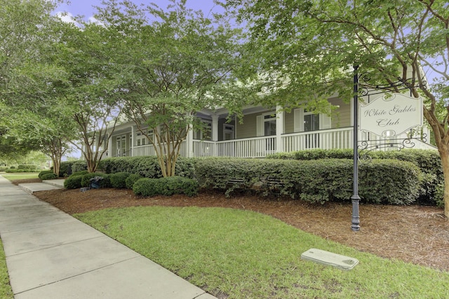 view of front of home with a front yard and covered porch