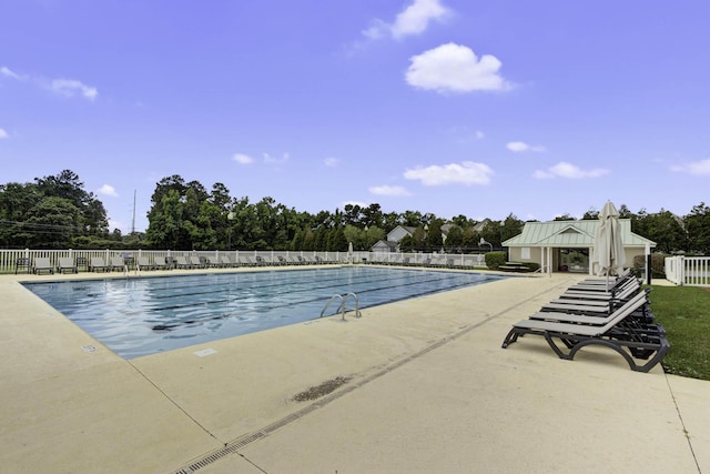 community pool featuring a patio area and fence
