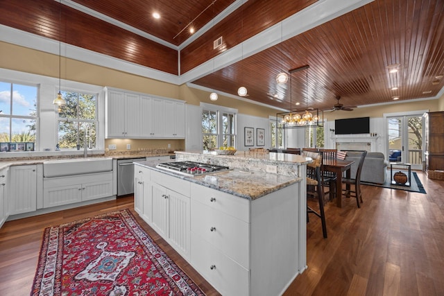 kitchen with a kitchen island, appliances with stainless steel finishes, wood ceiling, and a sink