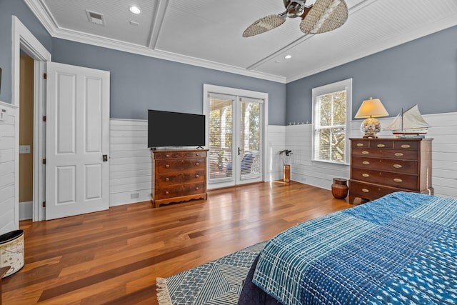 bedroom with visible vents, wood finished floors, access to exterior, and wainscoting