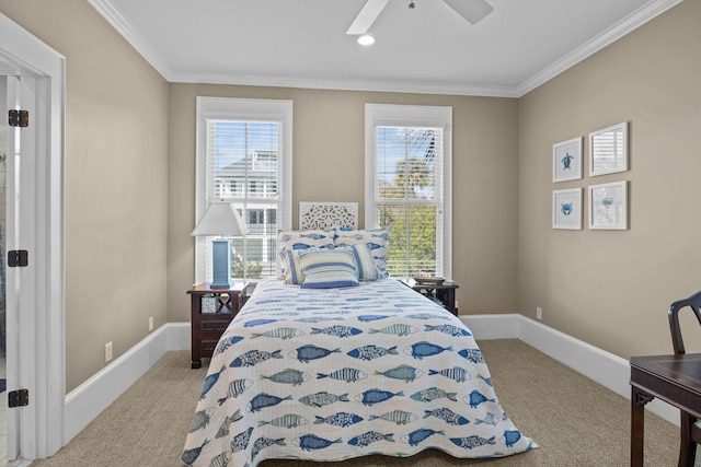 carpeted bedroom featuring ceiling fan, multiple windows, baseboards, and ornamental molding