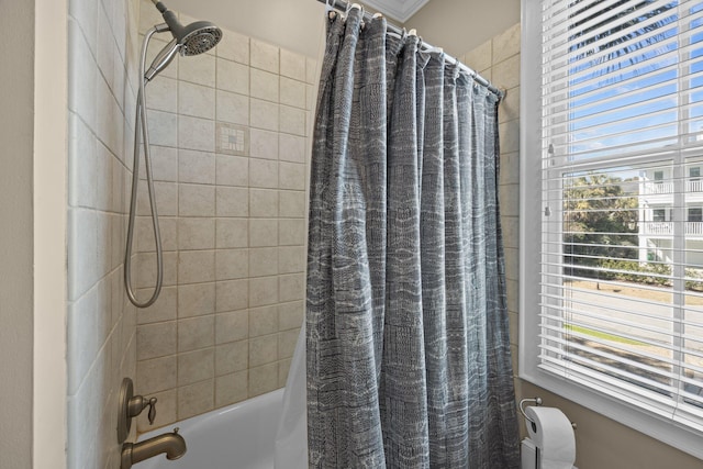 full bath featuring a healthy amount of sunlight and shower / tub combo