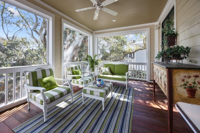 sunroom / solarium with a ceiling fan