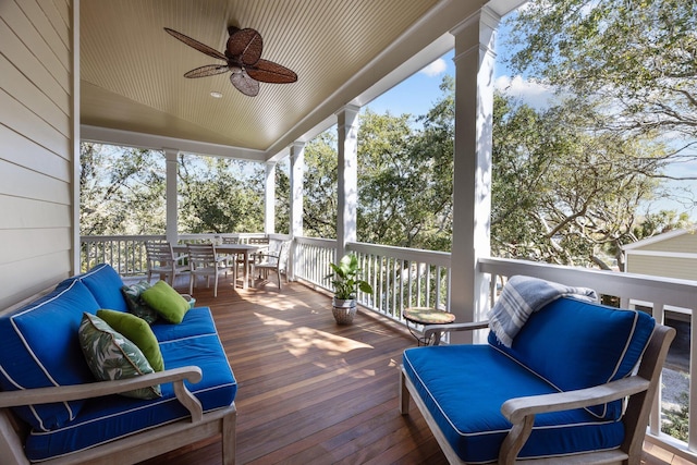 wooden deck with outdoor lounge area, outdoor dining area, and a ceiling fan