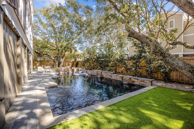 view of swimming pool featuring a fenced in pool, a lawn, a fenced backyard, and a patio area