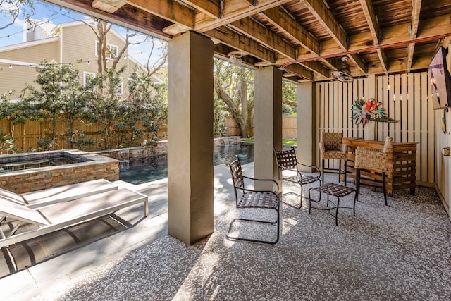 view of patio featuring an outdoor pool, an in ground hot tub, and a fenced backyard