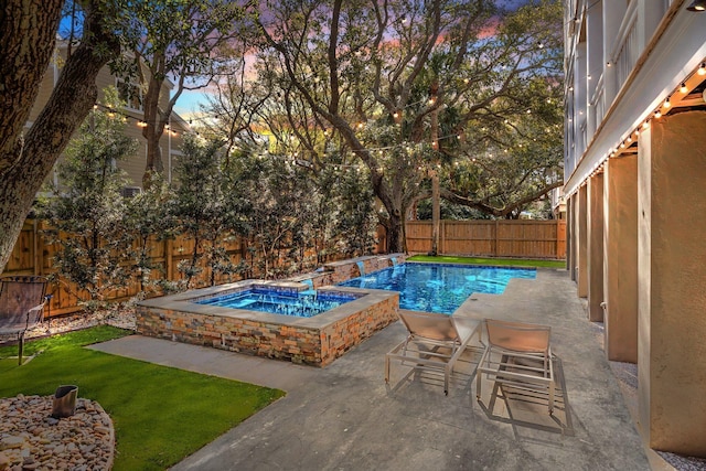 view of swimming pool featuring a patio area, a fenced in pool, an in ground hot tub, and a fenced backyard