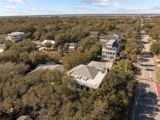 birds eye view of property featuring a forest view