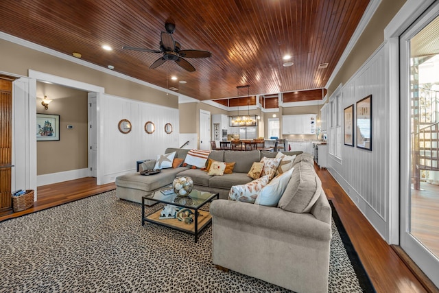 living room with a ceiling fan, crown molding, wood finished floors, and wooden ceiling