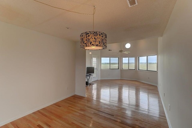 unfurnished room with light hardwood / wood-style flooring and ceiling fan