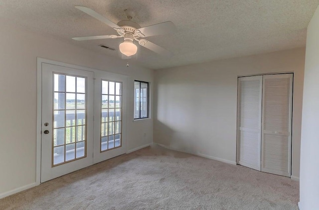 unfurnished bedroom with a closet, light carpet, and ceiling fan