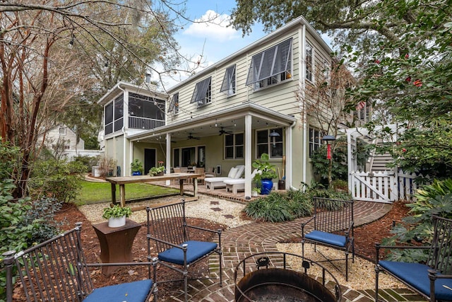 rear view of house with a patio area, a sunroom, and ceiling fan