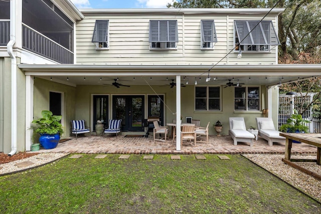 rear view of house featuring a patio, a yard, ceiling fan, and french doors