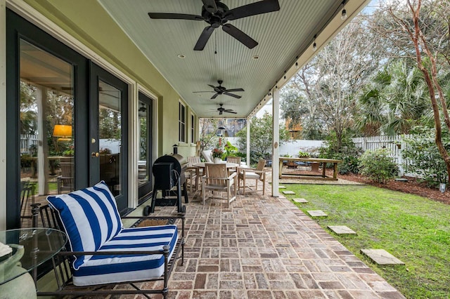 view of patio featuring ceiling fan and a grill