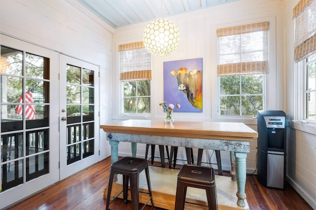 dining room featuring dark hardwood / wood-style flooring, french doors, and a healthy amount of sunlight