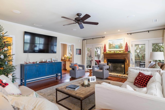 living room featuring french doors, ceiling fan, crown molding, and hardwood / wood-style floors