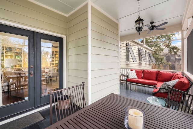 wooden terrace featuring an outdoor living space and french doors