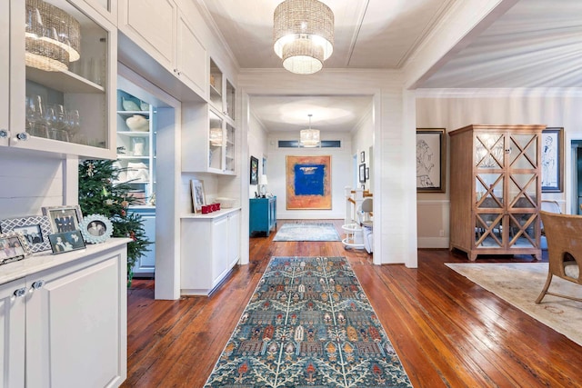 interior space with ornamental molding and dark hardwood / wood-style floors