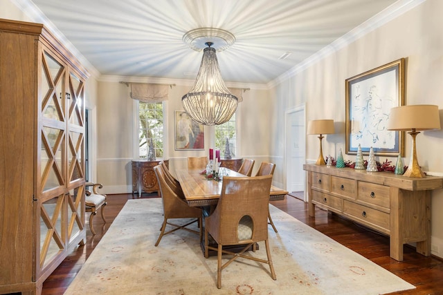 dining room with crown molding, dark wood-type flooring, and a chandelier