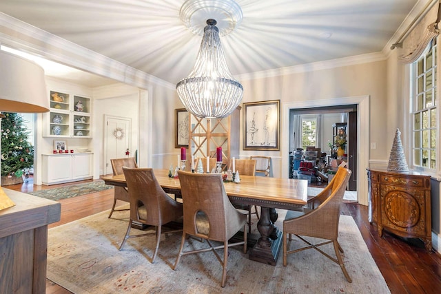 dining room with ornamental molding, plenty of natural light, dark hardwood / wood-style floors, and a notable chandelier